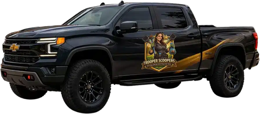 Black Chevrolet pickup with large tires, gold side stripe, and door decal of a woman holding scoops and bags labeled 'Trooper Scoopers'.